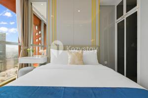 a bedroom with a white bed and a large window at Altin by Kozystay - TB Simatupang in Jakarta +20 photos