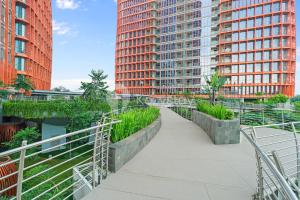 a walkway in a city with tall buildings at Altin by Kozystay - TB Simatupang in Jakarta
