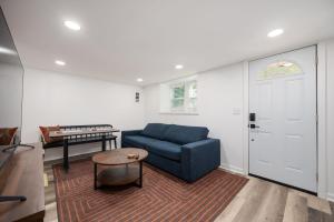 a living room with a blue couch and a table at Chic 2-Bed Haven with Vibrant Décor in SE Atlanta in Atlanta