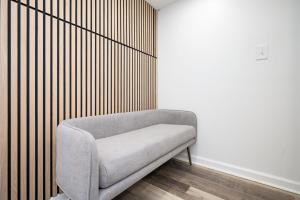 a gray couch sitting in a corner of a room at Chic 2-Bed Haven with Vibrant Décor in SE Atlanta in Atlanta +19 photos