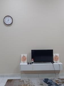 a living room with a tv on a white wall at Homestay sekamat ,kajang in Kajang
