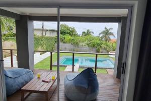 a living room with a view of a pool at Ballito Home, Private Pool & Solar in Ballito