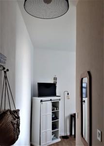 Zimmer mit einem Spiegel und einem Tisch mit einem Laptop in der Unterkunft Studio vue mer 1r étage avec balcon in Les Sables-dʼOlonne + 9 Fotos