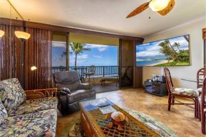a living room with a view of the ocean at SUGAR BEACH RESORT, #414 condo in Kihei