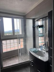 a bathroom with a shower and a sink at Ogooué appartement entier Lumineux 94m2 in Carpentras +75 photos