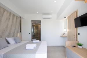 Ένα ή περισσότερα κρεβάτια σε δωμάτιο στο Oasis Serenity +24 φωτογραφίες