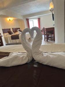 Cama ou camas em um quarto em Hotel Hacienda María Eugenia Acapulco