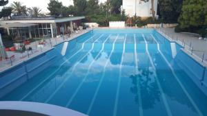 a large swimming pool with blue water at Casa Margot in Sanremo