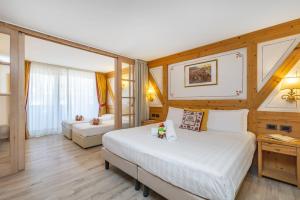 Postel nebo postele na pokoji v ubytování Piz Galin Grand Hotel Family & Wellness