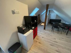 a living room with a flat screen tv on a dresser at Francis Apartment II - Spa Center Karlovy Vary in Karlovy Vary