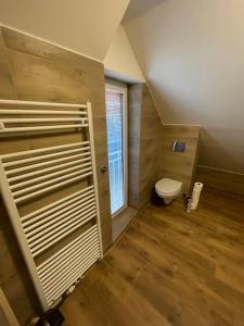 a small bathroom with a toilet and a window at Francis Apartment 2 - Lázeňské centrum in Karlovy Vary
