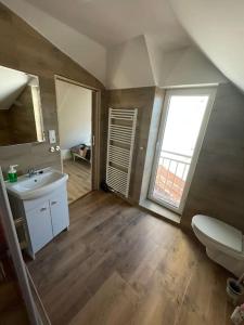 a bathroom with a sink and a toilet and a window at Francis Apartment II - Spa Center Karlovy Vary in Karlovy Vary +15 photos