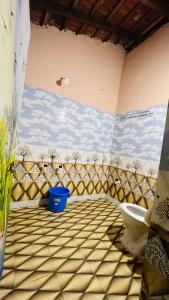 a bathroom with a toilet in a room at Nakshatra Beach Stay in Gokarn