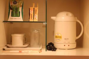 a coffee maker on a shelf in a kitchen at Hotel Bianca Due (Adult Only) in Tokyo