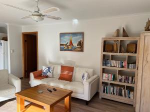 a living room with a couch and a coffee table at Lazy Sails Port - Pets welcome inside WiFi in Robe