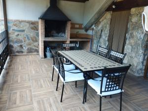 a dining room with a table and chairs and a fireplace at Haza Del Puente in Riópar
