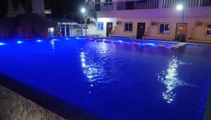 a swimming pool at night with blue lights at Baie Benie Beach Resort in Balibago