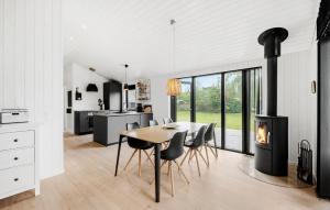 a kitchen and dining room with a wood stove at 3 Bedroom Nice Home In Store Fuglede in Store Fuglede