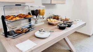 a table with a bunch of pastries on it at Perla Suite in Mesagne