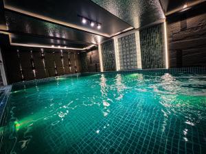 a swimming pool with green water in a building at Hải Long Hotel 1 in Vung Tau