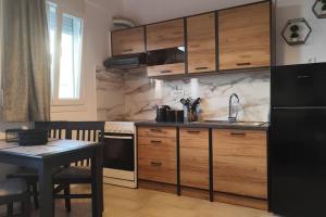 a kitchen with a black refrigerator and a table at S & d loft in Heraklio