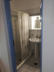 a bathroom with a shower and a sink at Blue House in Acherounes +46 photos
