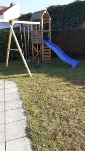a playground with a blue slide and a gazebo at a l'aise aan zee in Koksijde +34 photos