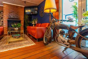 a living room with a motorcycle and a couch at Hotel Restaurant Argos, Strasbourg Nord in Vendenheim