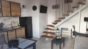 a kitchen and living room with a spiral staircase at S & d loft in Heraklio
