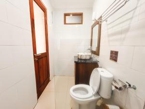 a bathroom with a toilet and a sink at Rostika Hotel Sekumpul in Pabean Buleleng