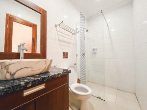 a bathroom with a sink and a toilet at Rostika Hotel Sekumpul in Pabean Buleleng +93 photos