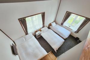 Ένα ή περισσότερα κρεβάτια σε δωμάτιο στο Sunshine Hakuba Ski-to-door by JAMSZ ROYALE +24 φωτογραφίες