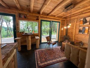 a living room with a couch and a table in a cabin at Living Forest Resort in Moravske-Toplice