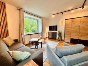 a living room with a couch and a window at Apartment Christl in Sankt Jakob in Defereggen
