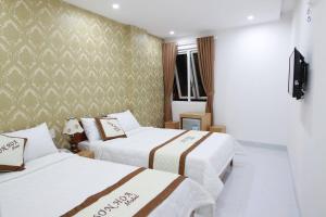 Ένα ή περισσότερα κρεβάτια σε δωμάτιο στο Motel Sơn Hoa