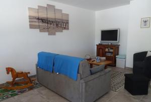 ein Wohnzimmer mit Sofa und Fernseher in der Unterkunft Maison proche de Royan à Meschers sur Gironde 2 chambres in Meschers-sur-Gironde