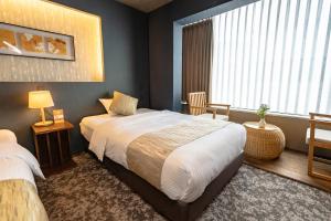 Ein Bett oder Betten in einem Zimmer der Unterkunft 谷町君Hotel 松竹雲 京都四条烏丸