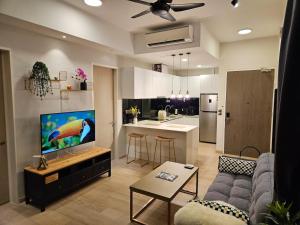 a living room with a couch and a kitchen at Star Residence 2br Unit Floor 46 in Kuala Lumpur