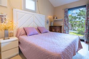 a bedroom with a large bed and a window at Domus de Rocas Holiday House in Porto Rotondo