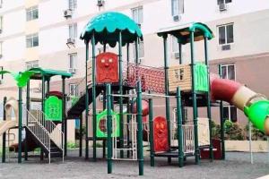 a playground with a slide in a park at DDs holistay in Lapu Lapu City
