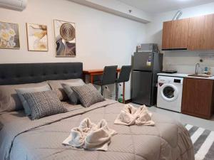 a bedroom with a bed with towels on it at DDs holistay in Lapu Lapu City
