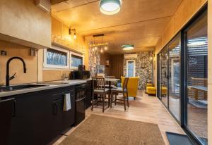 a kitchen and dining room with a dining table at Almásglamp in Zebegény