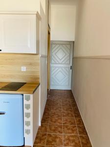 a kitchen with a counter and a closet with a door at Harmony Seaside Pelion in Platanias
