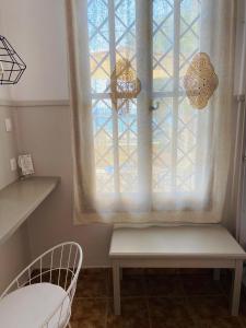 a window in a room with two chairs and a bench at Harmony Seaside Pelion in Platanias