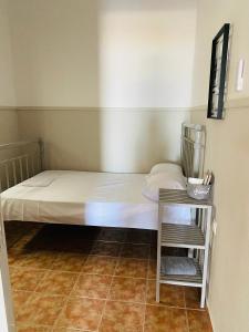a bed in a room with a side table at Harmony Seaside Pelion in Platanias
