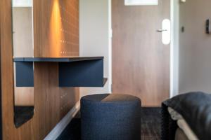 a living room with a stool and a door at Airport Hotel, Billund in Billund