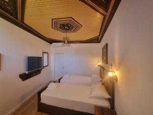 een slaapkamer met een bed met een schuin plafond bij HOTEL VILA TWIX in Berat