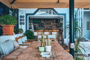 a wooden table in a restaurant with a bar at Aqua Princess Hotel in Kaş