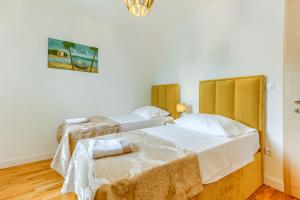 a bedroom with two beds and a chair in it at Villa ARIJANA 2 in Slatine