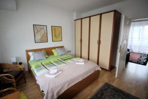 ein Schlafzimmer mit einem großen Bett und einem Schrank in der Unterkunft Apartman Mak in Bihać